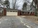 Charming one-story brick home with an attached garage and a driveway at 8328 S Franklin Rd, Indianapolis, IN 46259