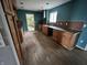 View of the kitchen with wood cabinets, countertops, backsplash, stainless range hood, and wood flooring at 8328 S Franklin Rd, Indianapolis, IN 46259