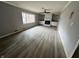 View of the living room with fireplace, built-in shelving and light wood flooring at 8328 S Franklin Rd, Indianapolis, IN 46259