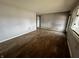 Spacious living room with wood floors, light gray walls and a large window at 8328 S Franklin Rd, Indianapolis, IN 46259