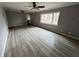 View of living room, featuring light wood flooring and large window at 8328 S Franklin Rd, Indianapolis, IN 46259