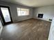 Living room showcasing wood floors, gray walls, fireplace, and natural light from the window at 8328 S Franklin Rd, Indianapolis, IN 46259