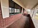 Covered porch with brick walls, white pillars, and view of surrounding area at 8328 S Franklin Rd, Indianapolis, IN 46259