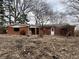 Rear exterior of a red brick home with a covered porch and backyard at 8328 S Franklin Rd, Indianapolis, IN 46259