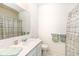 Well-lit bathroom featuring a single vanity with a light countertop, mirror and a shower with patterned curtain at 936 Plunkett Ave, Westfield, IN 46074
