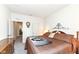 Well-lit bedroom featuring a large bed, a wall clock and a view into the hallway at 936 Plunkett Ave, Westfield, IN 46074