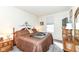 Bedroom with tan bedding, side table, lamps, and natural light from the window at 936 Plunkett Ave, Westfield, IN 46074