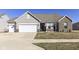 Charming home featuring vinyl siding, brick accents, and a well-manicured front yard, creating a welcoming curb appeal at 936 Plunkett Ave, Westfield, IN 46074