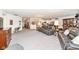 Open-concept living room featuring plush carpeting, comfortable seating, and seamless flow into the kitchen and dining areas at 936 Plunkett Ave, Westfield, IN 46074