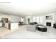 Open concept living and kitchen area with stainless steel appliances, fireplace, and a cozy gray sofa at 936 Plunkett Ave, Westfield, IN 46074