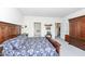 Spacious main bedroom featuring wood furniture, including wardrobe and king-size bed with blue floral pattern bedding at 936 Plunkett Ave, Westfield, IN 46074