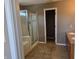 A full bathroom featuring a shower and tub combo with tile walls and double sinks at 9808 Worthington Blvd, Fishers, IN 46038