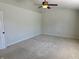 A spacious bedroom with carpet, neutral walls, a ceiling fan, and a large window at 9808 Worthington Blvd, Fishers, IN 46038
