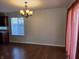 Open dining area featuring hardwood floors, a modern chandelier, and natural light at 9808 Worthington Blvd, Fishers, IN 46038