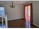 Open dining area featuring hardwood floors, a modern chandelier, and natural light at 9808 Worthington Blvd, Fishers, IN 46038