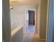 Hallway with white closet doors and a carpeted floor with a view of an adjacent room at 9808 Worthington Blvd, Fishers, IN 46038