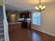 Open kitchen design with stainless steel appliances, breakfast bar, and wood floors at 9808 Worthington Blvd, Fishers, IN 46038