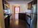 Kitchen featuring stainless steel appliances, dark cabinets, and an open floorplan at 9808 Worthington Blvd, Fishers, IN 46038
