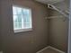 A walk-in closet with shelving and carpet, featuring a window at 9808 Worthington Blvd, Fishers, IN 46038