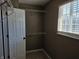 A walk-in closet with shelving and carpet, featuring a window at 9808 Worthington Blvd, Fishers, IN 46038