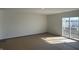 Bright living room with sliding glass door, offering access to the outdoors and ample natural light at 10265 Cliff Ln, Indianapolis, IN 46239
