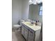 Cozy bathroom featuring a vanity with drawers, a sink, a mirror, and a toilet at 1031 Schleicher Ave, Indianapolis, IN 46229
