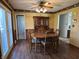 Dining room has hardwood floors, vintage hutch, wood table and chairs, and access to a bathroom at 1031 Schleicher Ave, Indianapolis, IN 46229