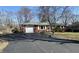 Red brick ranch-style home with attached garage and long asphalt driveway at 1031 Schleicher Ave, Indianapolis, IN 46229