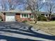 Red brick ranch-style home with attached garage and long asphalt driveway at 1031 Schleicher Ave, Indianapolis, IN 46229