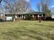 Charming red brick ranch-style home with attached garage and well-maintained front lawn and landscaping at 1031 Schleicher Ave, Indianapolis, IN 46229