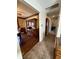 Hallway leading to dining room featuring hardwood floors and dark wood china cabinet at 1031 Schleicher Ave, Indianapolis, IN 46229