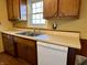 Kitchen area has stainless sink, dishwasher, window with wood cabinets, laminate flooring and countertops at 1031 Schleicher Ave, Indianapolis, IN 46229