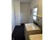 Functional laundry room with classic appliances, storage cabinet, and natural light from the window at 1031 Schleicher Ave, Indianapolis, IN 46229