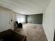 Spacious living room featuring neutral carpet, chair, and a green accent wall near the front door at 1031 Schleicher Ave, Indianapolis, IN 46229