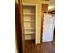 Pantry area in kitchen is large with floor to ceiling white shelving at 1031 Schleicher Ave, Indianapolis, IN 46229