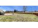 Spacious backyard featuring a grassy area, stone patio, and wooden fence at 10535 Pokagon Way, Indianapolis, IN 46239
