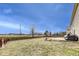 Backyard featuring a grassy area, patio, wooden fence, and mature trees at 10535 Pokagon Way, Indianapolis, IN 46239