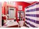 Bright bathroom featuring a decorative mirror, sink, and vibrant red painted walls at 10535 Pokagon Way, Indianapolis, IN 46239