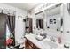 Bright bathroom featuring a double sink vanity and a large mirror at 10535 Pokagon Way, Indianapolis, IN 46239