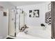 Elegant bathroom with a shower, soaking tub, and decorative artwork at 10535 Pokagon Way, Indianapolis, IN 46239