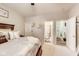 Bright bedroom with a queen-size bed, neutral walls, and access to the bathroom and closet at 10535 Pokagon Way, Indianapolis, IN 46239