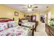 Bright bedroom featuring two double beds, ceiling fan, and access to other rooms at 10535 Pokagon Way, Indianapolis, IN 46239