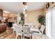 Dining room featuring a modern table set, stylish lighting fixture, and view into the kitchen at 10535 Pokagon Way, Indianapolis, IN 46239