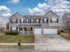 Charming two-story home with a brick facade, front porch, two-car garage, and well-manicured lawn at 10535 Pokagon Way, Indianapolis, IN 46239