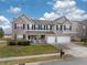 Attractive two-story home featuring a covered front porch, brick and siding, plus a two-car garage at 10535 Pokagon Way, Indianapolis, IN 46239