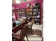 Cozy home office featuring a large desk, chairs, and filled bookshelves at 10535 Pokagon Way, Indianapolis, IN 46239