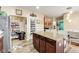 Open kitchen with modern appliances, an island with seating, and a pantry for storage at 10535 Pokagon Way, Indianapolis, IN 46239