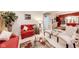 Cozy living room featuring red sofas, a glass coffee table, and elegant decor at 10535 Pokagon Way, Indianapolis, IN 46239