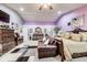 Spacious main bedroom featuring a seating area, ceiling fan, and neutral carpet at 10535 Pokagon Way, Indianapolis, IN 46239