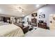 Large main bedroom with a seating area, ceiling fan, vaulted ceiling, and storage cabinet at 10535 Pokagon Way, Indianapolis, IN 46239